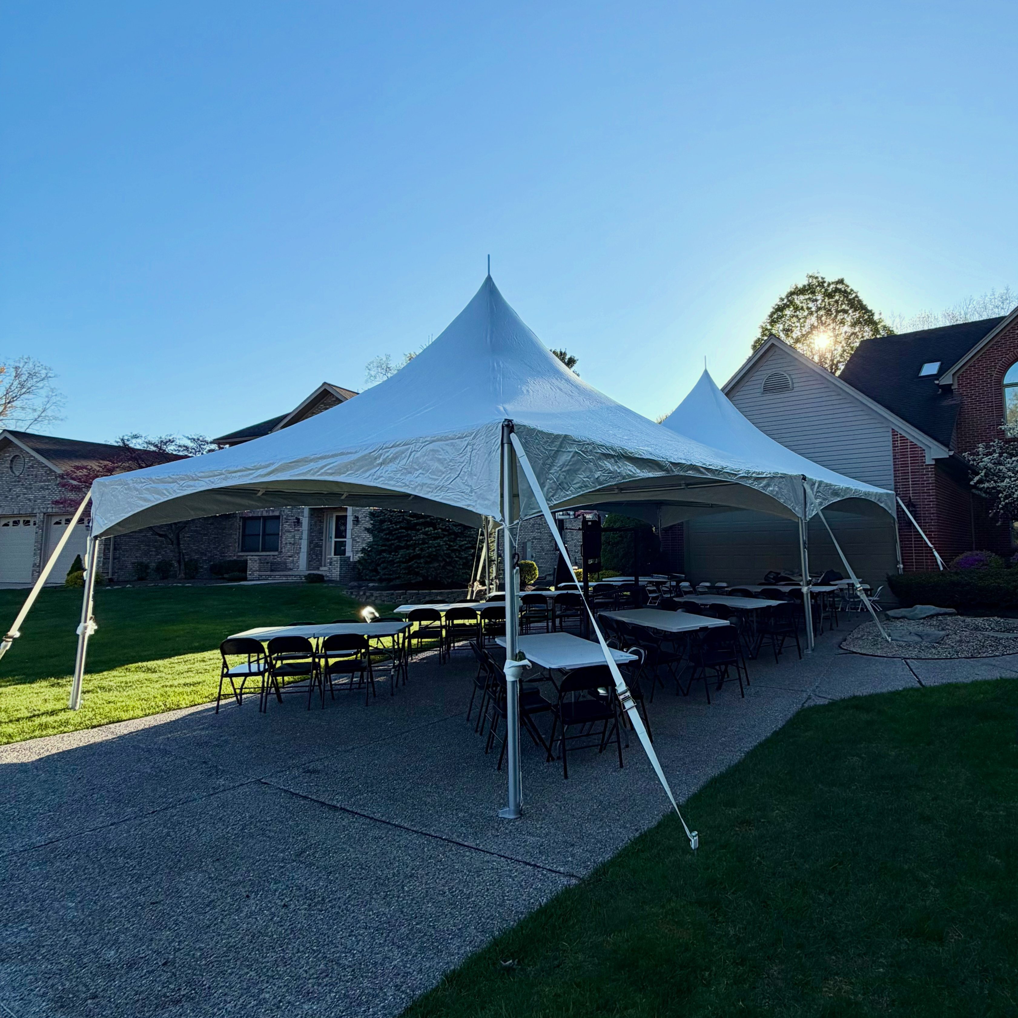 20x40 pole tent rental at dusk in Farmington Hills Michigan